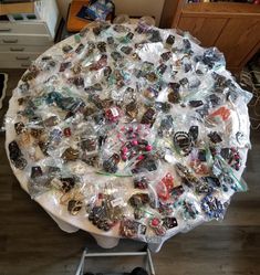 a round table covered with lots of different types of buttons and bracelets on it