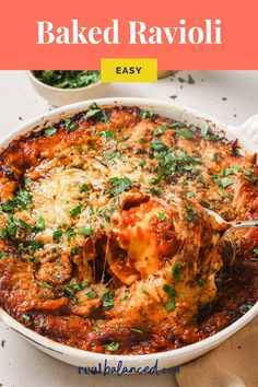 baked ravioli in a white casserole dish with parsley on top