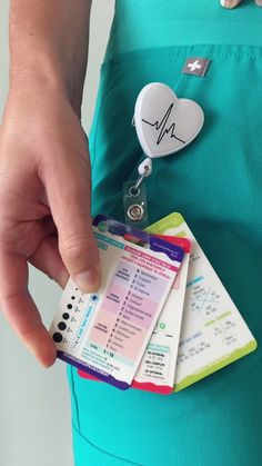 a person is holding several id cards in their pocket with a stethoscope attached to them