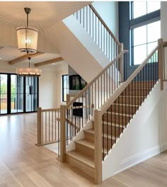 a large open floor plan with wood floors and white railings