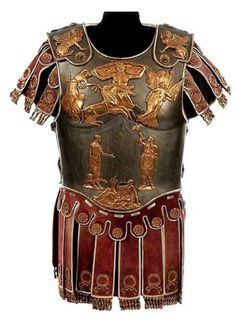 an ancient roman armor with gold and red accents on it's chest, which is decorated