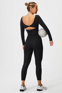 Oasis Twist Built-In Bra Long-Sleeve Top - Fabletics Black Elastane Tops For Pilates, Sporty Tops For Pilates In Fall, Black Elastane Workout Top, Black Elastane Tops For Workout, Elastane Workout Tops For Fall, Fall Workout Tops In Elastane, Fall Workout Tops Made Of Elastane, Black Sportswear Tops For Pilates, Black Fitted Top For Pilates