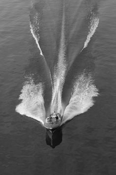 an aerial view of a speed boat in the water