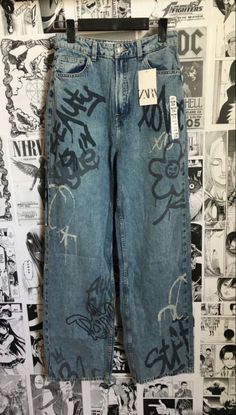 a pair of blue jeans with graffiti on them