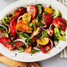 a white bowl filled with lots of different types of vegetables