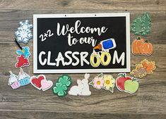 a welcome sign surrounded by magnets on a wooden floor