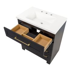 a white sink sitting next to a black cabinet with drawers on it's sides