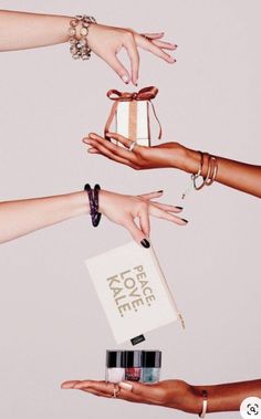 four hands reaching out to each other holding a gift box with the words for love on it