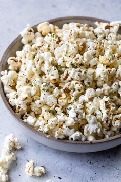 a bowl filled with popcorn sitting on top of a table