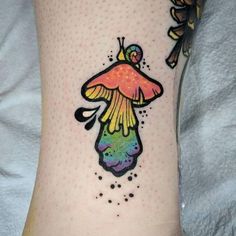 a colorful tattoo on the leg of a woman