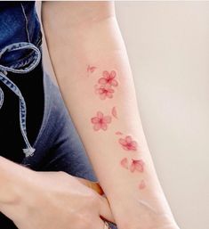 a woman's arm with flowers on it