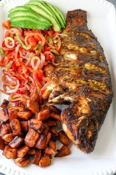 a white plate topped with meat and veggies