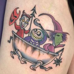 an image of a halloween themed tattoo on someone's thigh with two witches in a bathtub