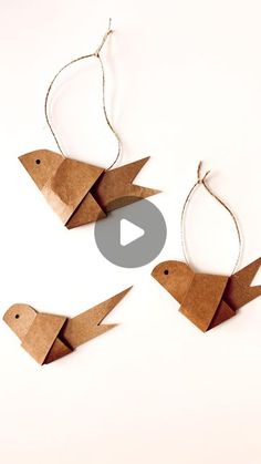 three origami birds hanging from strings