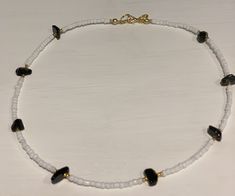 Beautiful beaded necklace containing pretty black onyx gemstone chips and white and gold glass seed beads Gold plated fastenings Other gemstones available, please check out my other listings or drop me a message and I can make up in your desired stone As this contains natural gemstones - they may vary slightly in colour, shape, design and size As this item contains small parts please keep away from small children as it may be a choking hazard To prevent damage please remove before swimming, show Elegant Heart-shaped Jewelry With Colorful Beads, Elegant Heart-shaped Colorful Beads Jewelry, Elegant Heart-shaped Colorful Beaded Jewelry, Adjustable Heart-shaped Gemstone Beads Jewelry, Heart-shaped Colorful Beads For Gifts, White Necklace With Tiny Oval Beads, Costume Jewelry Necklaces With Round Beaded Chain, Adjustable Czech Glass Necklace With Colorful Beads, Gold Heart Necklace With Colorful Beads