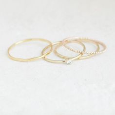 Ad a touch of sparkle to your stacking set with a tiny 2 mm cz diamond ring and three stacking bands. These four stack bands are super slim, hand formed, hammered and come made to order in US sizes 5 - 9!  Our gold stacking rings are perfectly dainty for wearing alone, as a knuckle ring or as a set.  We'll create your custom set of gold stacking rings in a mix-and-match of styles that you select from the drop-down menu. Combo shown in first image is the cz diamond with pebbled, twist and hammere Delicate Hammered Ring Jewelry, Delicate Hammered Jewelry Ring, Dainty Hammered Stackable Wedding Rings, Everyday Stackable Diamond Rings, Dainty Hammered Rings, Everyday Diamond Stackable Midi Rings, Everyday Stackable Diamond Midi Rings, Hammered Diamond Promise Ring, Dainty Diamond Cut Ring