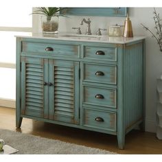 a bathroom vanity with two sinks and shuttered doors