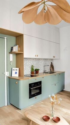 a kitchen with blue cabinets and an island in front of the stove top is shown