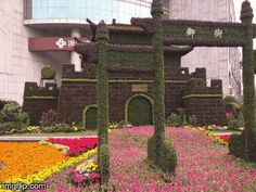 an elaborate display of flowers in front of a building