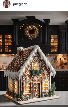 a gingerbread house is decorated with icing and lights