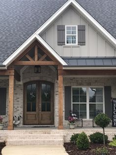 the front entrance to a home with stone and wood trimmings on the side