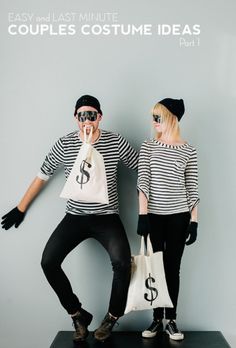 two people standing next to each other with bags in front of their faces and one holding a dollar sign