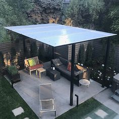 an outdoor patio with furniture and a solar panel on the roof