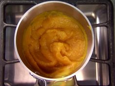 a pan filled with food sitting on top of a stove