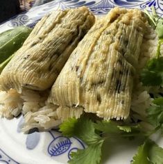 two pieces of food on a plate with cilantro