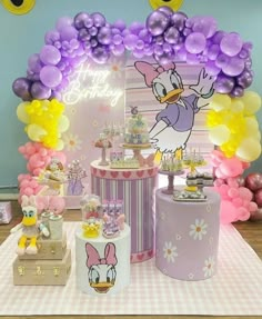 an image of a birthday party setting with balloons and food items on the table in front of it