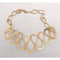 This is part of Chairish’s Costume Jewelry assortment.  Early 1970s Modernist goldtone wavy wire front with oval links at the back and security chain necklace with hook clasp. Marked "Napier" on the hook. Center measures: 2 1/4 inches long. Overall measures: 7 1/4 inches long by 6 inches wide. Interior circumference is about 16 7/8 inches at the largest setting. Condition: Very good; some wear to goldtone throughout. The matching ring and hair clip were featured in a 1970 Napier advertisement. Vintage Gold Necklace With Hooks And Links, Vintage Gold Necklace With Hook And Links, Retro Gold Metal Chain Necklace, Retro Gold Chain Necklace, Hook Clasp, Accessories Jewelry Necklace, Matching Rings, Modern Branding, Vintage Costume Jewelry