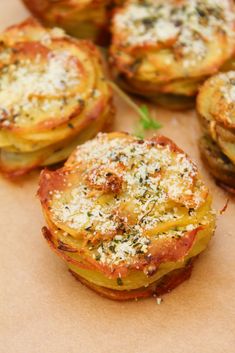 some food that is sitting on top of a piece of paper with cheese and herbs