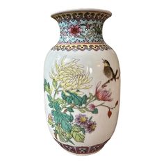 a white vase with flowers and birds painted on the side, sitting against a white background