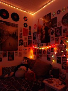 a bedroom with posters and lights on the wall