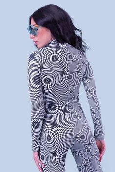 An amalgamation of surreal imagery. Pair with the matching flares for a finished look. FEATURES: > Mock Neckline > Long Sleeves > Flattering Form-Fitting Construction > Luxurious & Silky, Non–Transparent Lycra Fabric