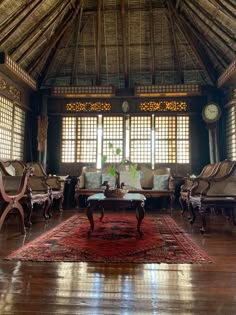 a living room filled with lots of furniture and windows