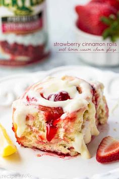 a piece of strawberry bundt cake with icing and strawberries on a plate