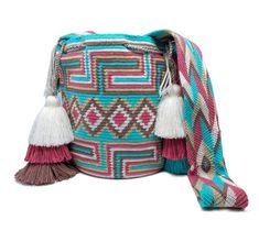 a multicolored bag with tassels on the front and side, sitting against a white background