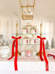 a table topped with lots of glass shelves filled with christmas decorations and candlesticks