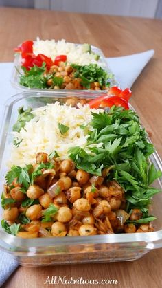 two plastic containers filled with food on top of a wooden table