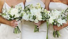 three bridesmaids holding bouquets of white flowers