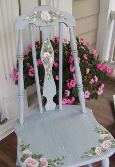 a blue chair with flowers painted on it