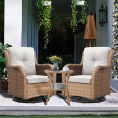 two wicker chairs sitting next to each other in front of a house with potted plants