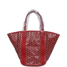 This limited edition reversible Goyard Eden Rock/St Barths Belharra beach bag is in red Goyardine canvas and chevroches calfskin leather, features "ER, Eden Rock, St. Barths" painted on the front, has contrast stitching, red canvas trim down front and back, one single slip pocket on front of bag, two leather top handles. The interior of the tote bag is lined with striped red and white canvas. The beach towel included is of red terry cloth and is multicolored with printed floating buoys.Origin: FranceCondition: New and never worn (plastic on hardware)Accompanied by: Dustbag, retail tag, strap dustbag, towel dustbagMeasurements: tote: 23.5" x 13" x 8.75"; beach towel: 36" x 60" Luxury Leather Trim Bags For Vacation, Luxury Leather Shoulder Bag For Vacation, Designer Red Bags With Leather Trim, Luxury Red Shoulder Bag With Leather Trim, Red Coated Canvas Shoulder Bag For Errands, Red Leather Trim Shoulder Bag For Shopping, Red Shoulder Bag With Leather Trim For Shopping, Red Leather Trim Shopping Bag, Red Shopping Bag With Leather Trim