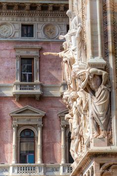 an ornate building with statues on the outside