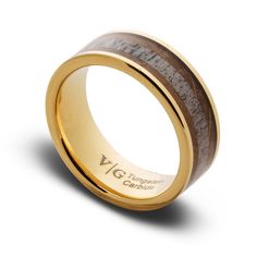 a gold ring with wood inlaying the center and engraving on the outside side