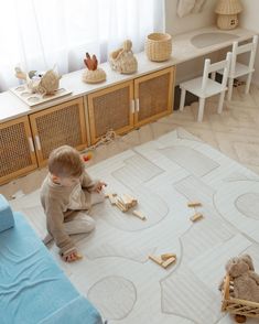 a toddler playing with wooden toys on the floor