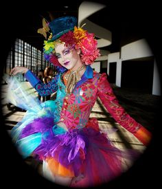 a woman dressed in colorful clothing and headpieces