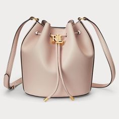 Lauren Ralph Lauren's Andie Small Leather Drawstring Bag Provides Ample Storage For Your Essentials And Features An Oversize "Lrl" Metal Stopper For An Iconic Finish. Small Sized Bag; 8-1/4"W X 11-3/4"H X 5-3/4"D (With Is Measured Across The Bottom Of Handbag); 0.92 Ibs. Approx. Weight Silhouette Is Based Off 5'9" Model 20"L Adjustable Strap Drawstring Closure With Polished "Lrl" Metal Stopper & Magnetic Snap Closure Gold-Tone Hardware Interior Slip Pocket Dust Bag Included Leather; Lining: Polyester Professional Leather Clean Dust Bag Included. Classic Pink Bag With Dust Bag Included, Elegant Pink Pouch Bucket Bag, Classic Pink Evening Bag, Classic Pink Evening Bags, Chic Pink Bucket Bag For Evening, Classic Pink Bag For Formal Occasions, Classic Pink Bags For Formal Occasions, Classic Pink Formal Bag, Designer Pink Bucket Bag For Travel