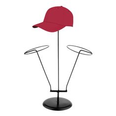 a red hat is on top of a black stand with two wire arms and a curved brimmed visor